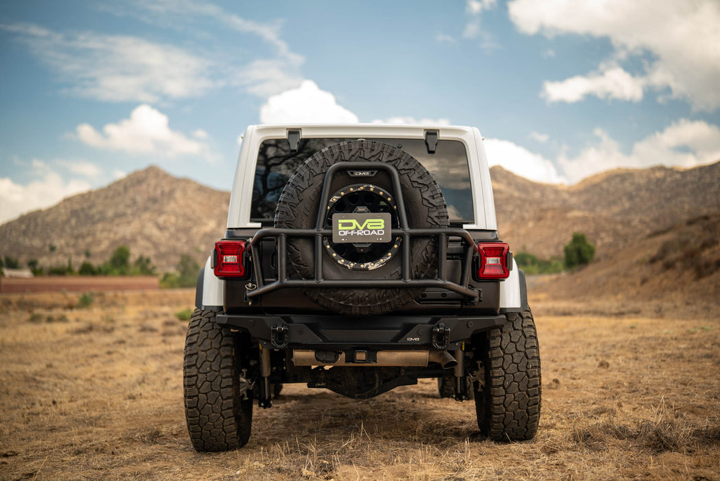 White off-road 2018-2025 Jeep Wrangler JL Body Mounted Tire Carrier with spare tire on a desert landscape