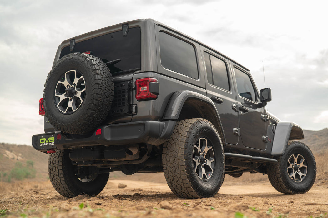 Gray Jeep Wrangler with Jeep Wrangler JL Tailgate Reinforcement Molle Panel Installed in a desert landscape