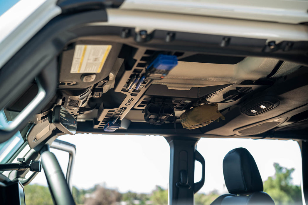 Jeep Wrangler & Gladiator Overhead Molle Panel with radios and bags attached.