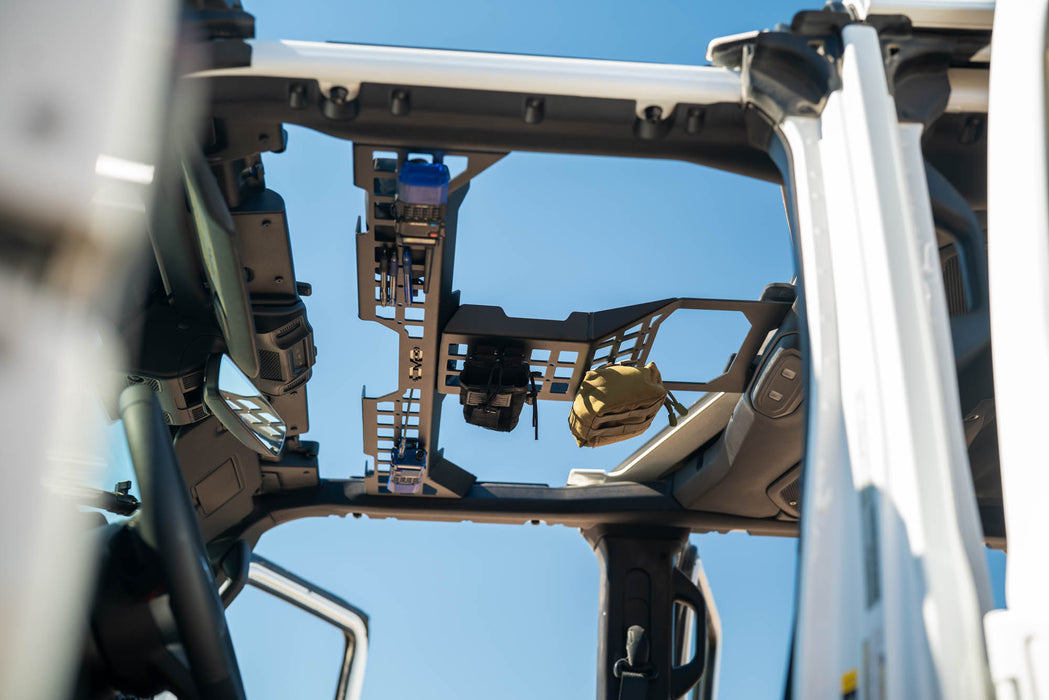 Close-up of Jeep Wrangler & Gladiator Overhead Molle Panel inside a vehicle with a clear blue sky background
