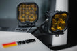 Installed 2024+ Toyota Land Cruiser Ditch Light Brackets with amber offroad lights on the driver's side hood hinge