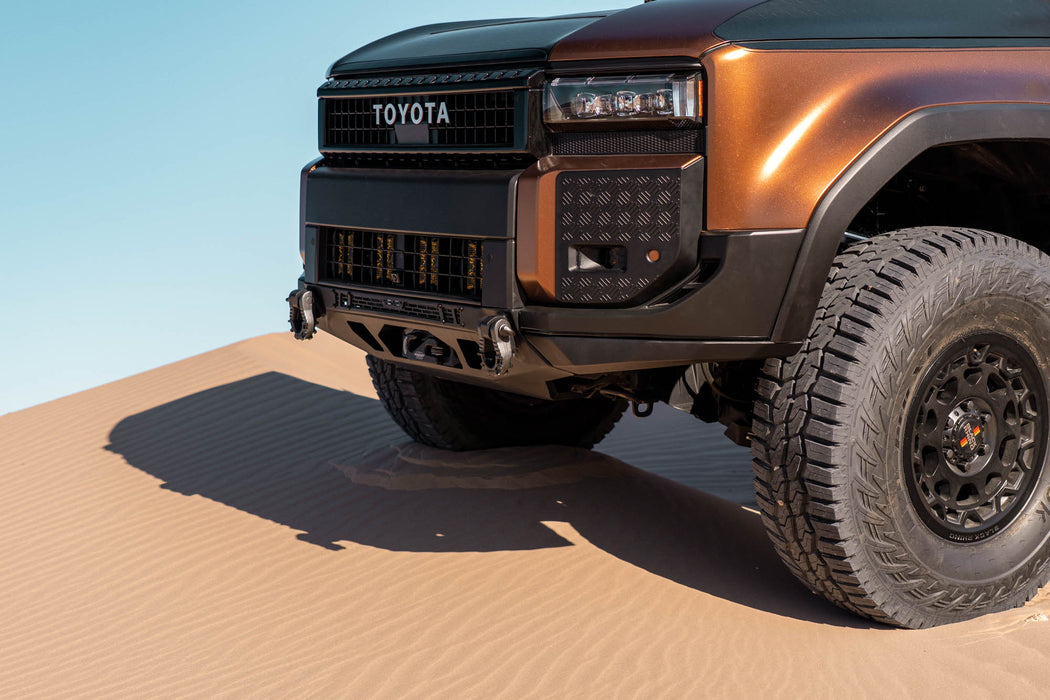 250 Series Land Cruiser with Spec Series Front Bumper on a sandy dune with a clear blue sky