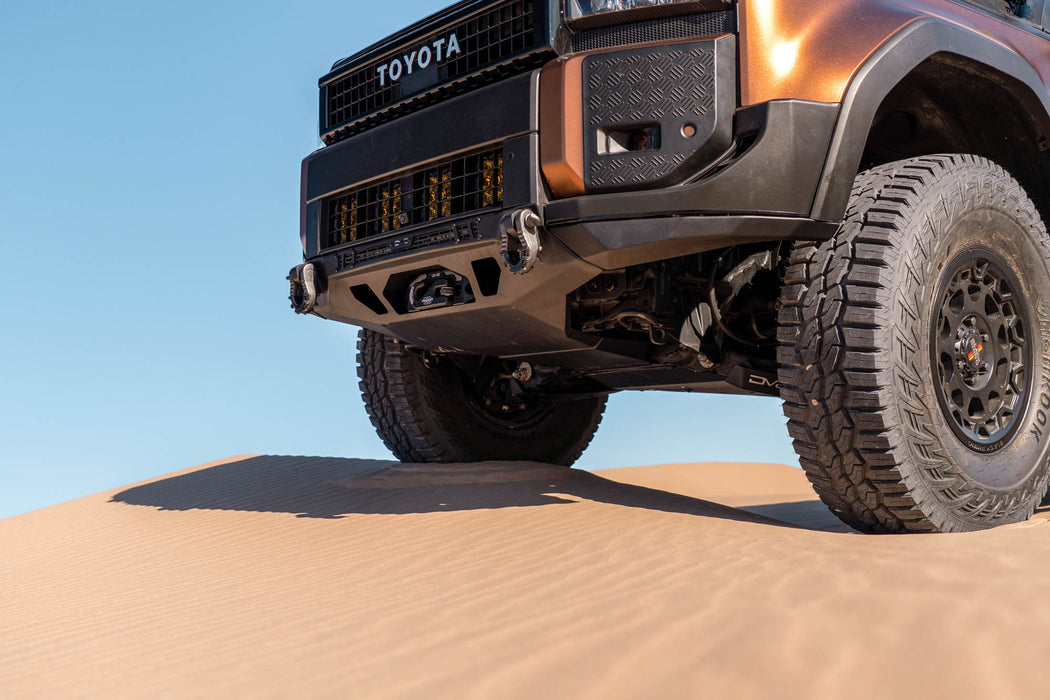 250 Series Land Cruiser with Spec Series Front Bumper on a sand dune with a clear blue sky