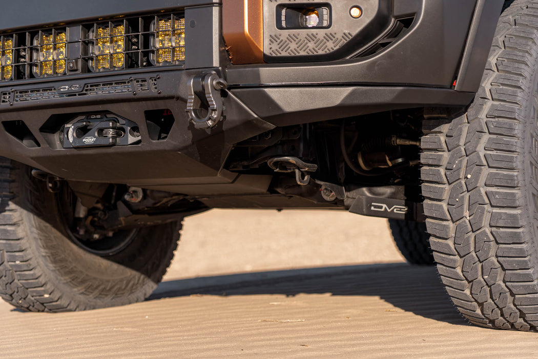 Close-up of 250 Series Land Cruiser with Spec Series Front Bumper and tire on a sand dune.