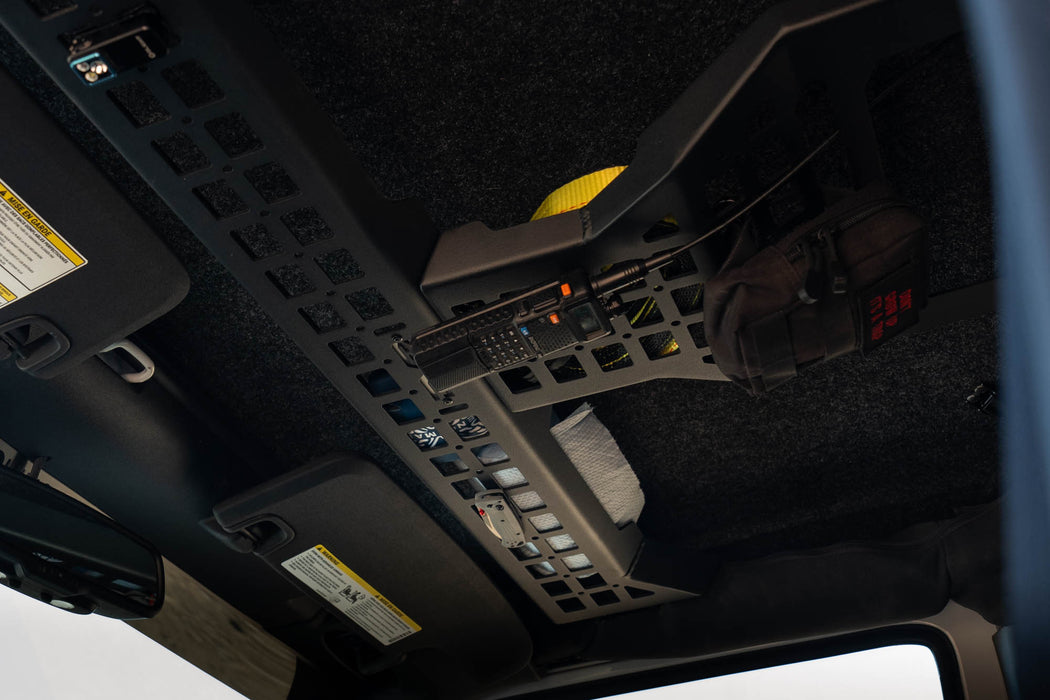 Overhead Molle Storage Panel for 2007-2018 Jeep Wrangler JK with CB radio and knife holder installed, and items stored above the panel