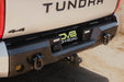 Angled view of 2022+ Toyota Tundra Spec Series Rear Bumper installed on pickup driving dirt roads