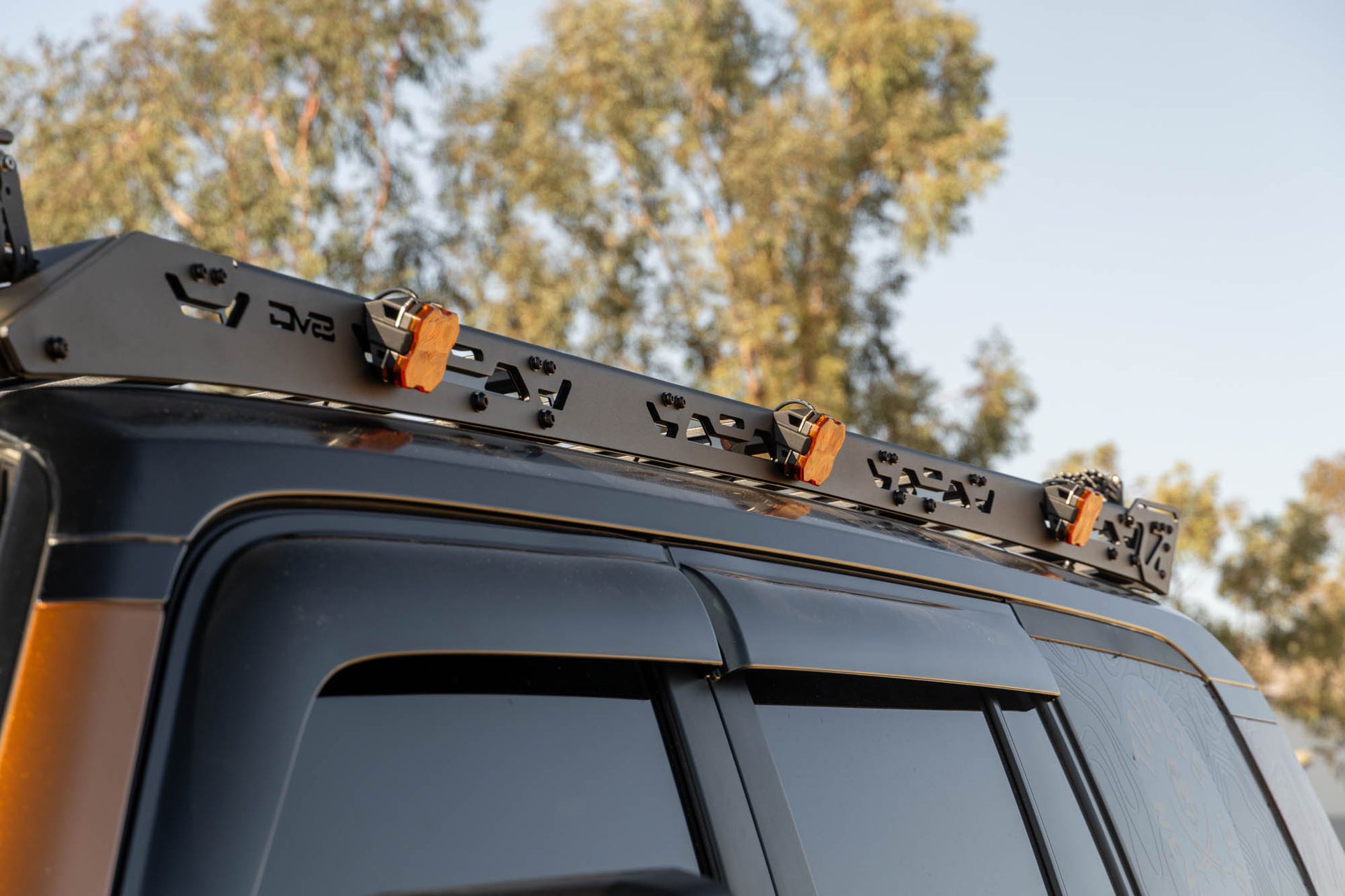 Roof rack system on a vehicle with trees in the background