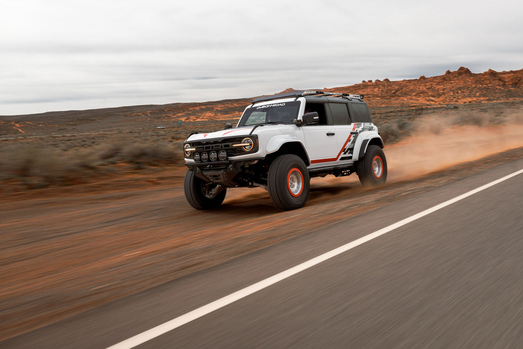 Ford Bronco Raptor with Tube Front Bumper driving on a desert road.