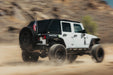 Image of jeep driving in fast motion with Universal Molle Adjustable Antenna & Whip Mount installed for flag off the rear door molle panel