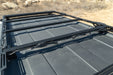DV8 Zip Tie Tabs used on roof rack crossbar holding wiring firmly in place on vehicle parked in the desert