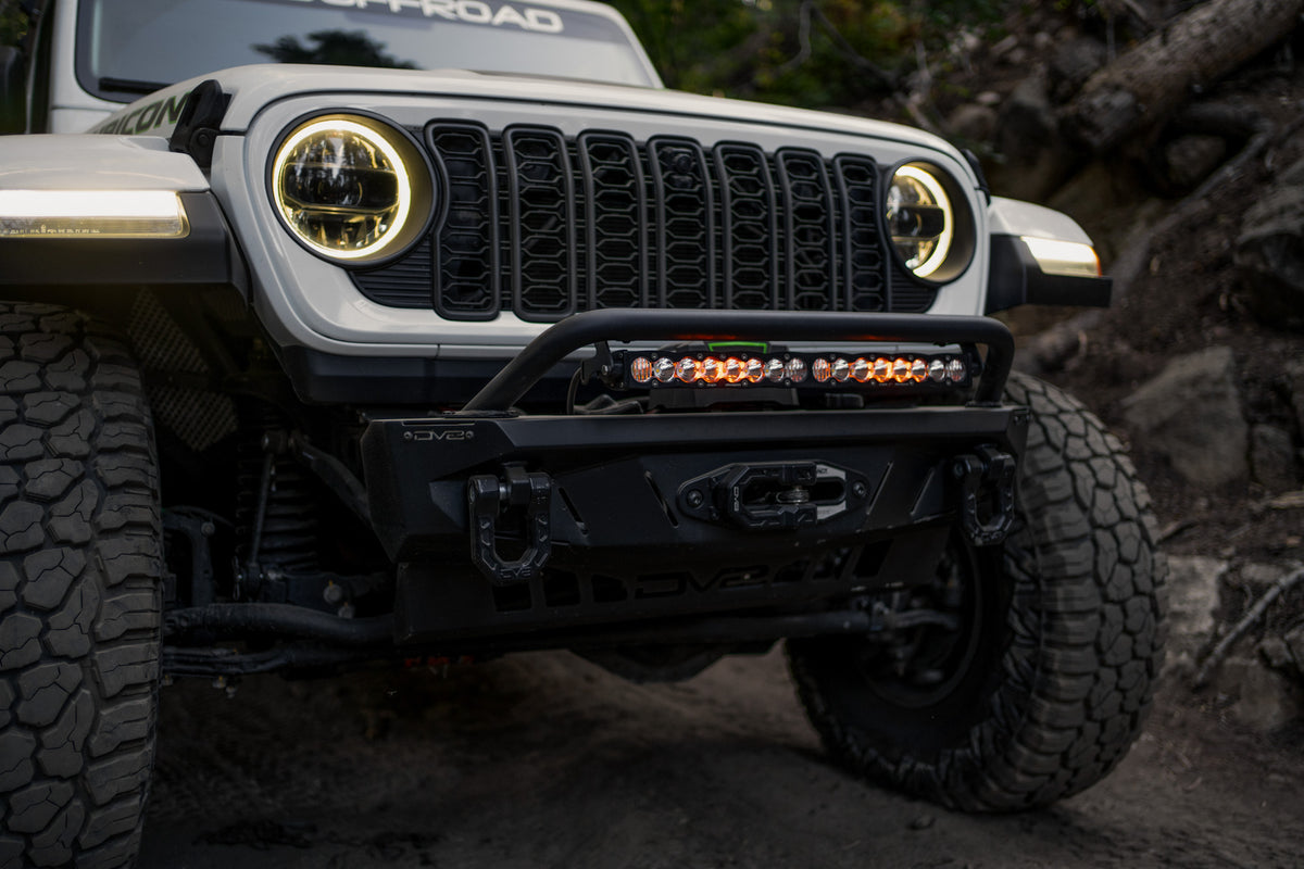 Front view of Jeep driving the trails with Spec Series bumper and the Universal Spec Series Bull Bar installed