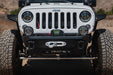Front view of installed DV8 Xtract 9.5k Synthetic Rope Winch on upgraded DV8 upgraded bumper for Jeep