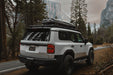 Roof Rack for the 250 Series Toyota Land Cruiser & Lexus GX 550 on a road surrounded by trees and mountains